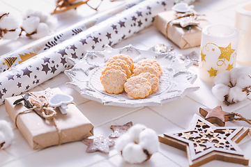 Image showing Christmas time, homemade cookies with ornaments and winter decorations in white