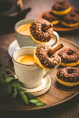 Image showing Two cups of Caffe Americano with small chocolate donuts