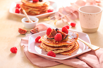 Image showing Sweet curd cheese pancakes with fresh raspberry, figs and maple sirup