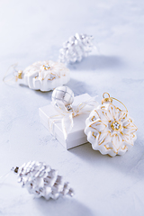 Image showing Christmas ornaments and small present in white