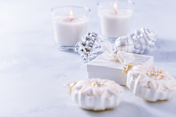 Image showing Christmas ornaments and small present in white