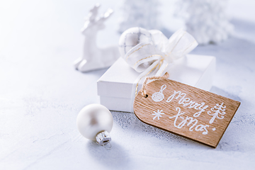 Image showing Christmas ornaments and small present in white