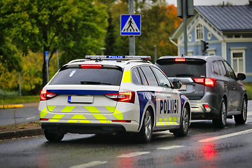 Image showing Police Vehicle Behind Car