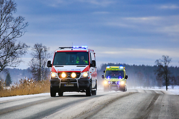 Image showing Two Ambulances on Call on Winter Road