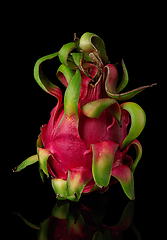 Image showing Dragon fruit vertically on a black background