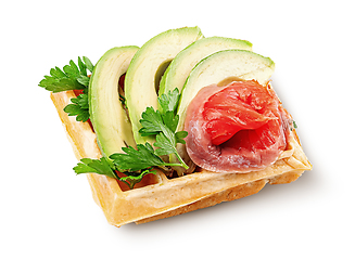 Image showing French waffle with avocado and salmon isolated on white