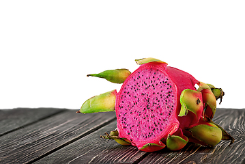 Image showing Half dragon fruit on planks isolated on white