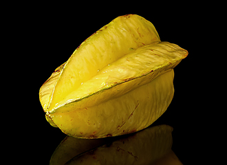 Image showing Ripe yellow carom rotated with reflection on black