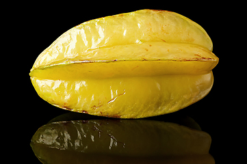 Image showing Ripe yellow carom with reflection on black