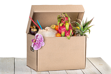 Image showing Tropical fruits in cardboard box isolated on white