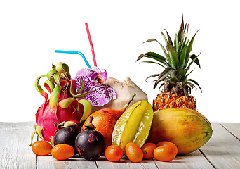 Image showing Tropical fruits on wooden table isolated on white