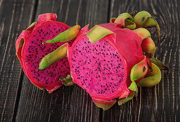 Image showing Two halves of dragon fruit on planks