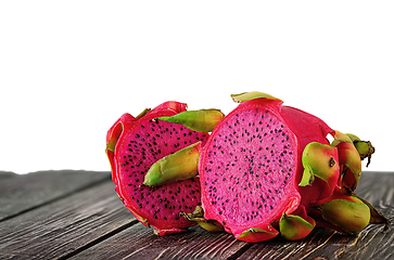 Image showing Two halves of dragon fruit on planks