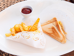 Image showing French fries and sandwiches on a plate