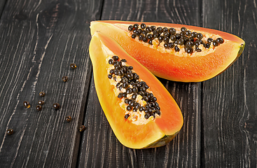 Image showing Two pieces of ripe papaya on a wooden table