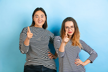 Image showing Young emotional women on gradient blue background