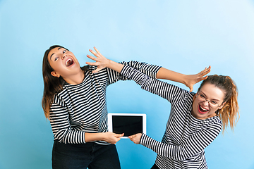 Image showing Young emotional women on gradient blue background