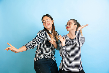 Image showing Young emotional women on gradient blue background