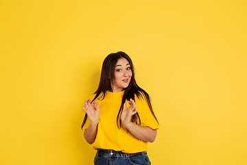 Image showing Caucasian woman\'s portrait isolated on yellow studio background