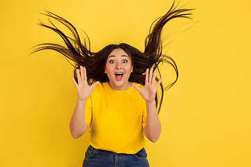 Image showing Caucasian woman\'s portrait isolated on yellow studio background