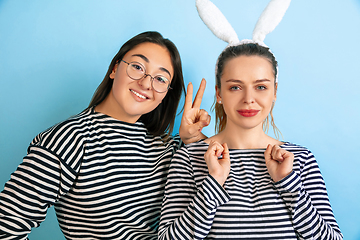 Image showing Young emotional women on gradient blue background