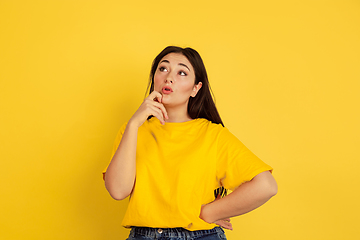 Image showing Caucasian woman\'s portrait isolated on yellow studio background