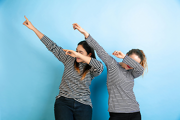 Image showing Young emotional women on gradient blue background