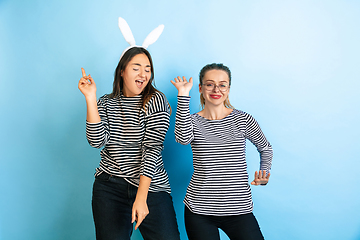 Image showing Young emotional women on gradient blue background