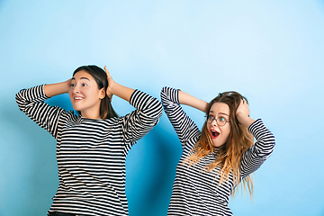 Image showing Young emotional women on gradient blue background