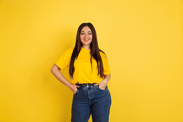 Image showing Caucasian woman\'s portrait isolated on yellow studio background