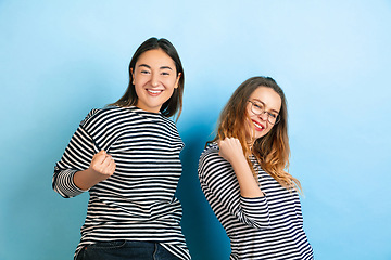 Image showing Young emotional women on gradient blue background