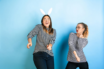 Image showing Young emotional women on gradient blue background