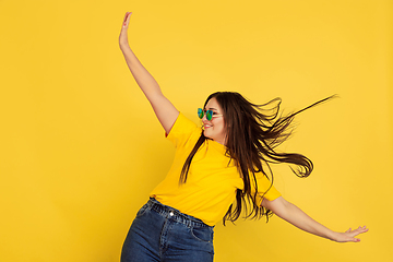 Image showing Caucasian woman\'s portrait isolated on yellow studio background