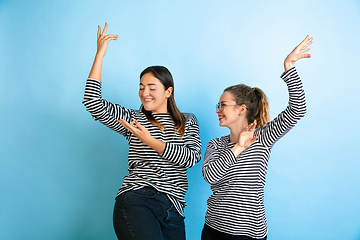 Image showing Young emotional women on gradient blue background