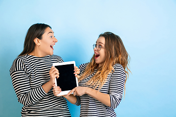 Image showing Young emotional women on gradient blue background