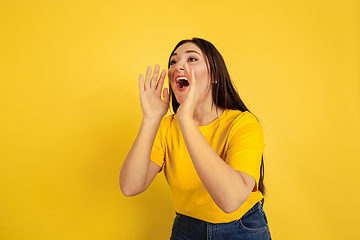 Image showing Caucasian woman\'s portrait isolated on yellow studio background