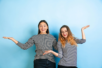 Image showing Young emotional women on gradient blue background