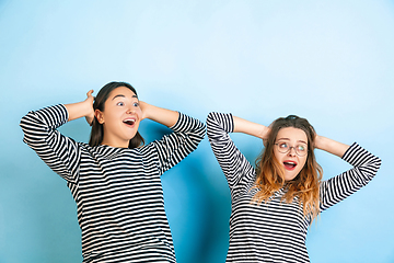 Image showing Young emotional women on gradient blue background