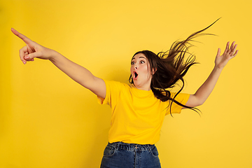 Image showing Caucasian woman\'s portrait isolated on yellow studio background