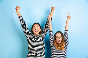 Image showing Young emotional women on gradient blue background