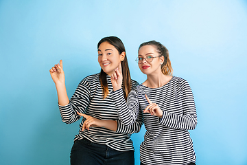 Image showing Young emotional women on gradient blue background