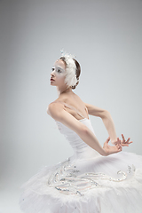 Image showing Close up of young graceful ballerina on white studio background