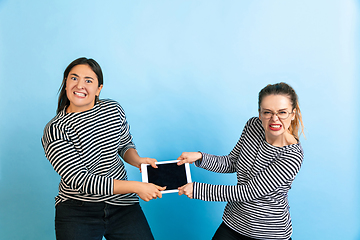 Image showing Young emotional women on gradient blue background