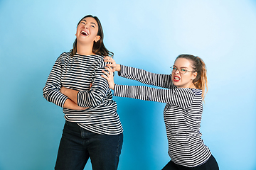 Image showing Young emotional women on gradient blue background