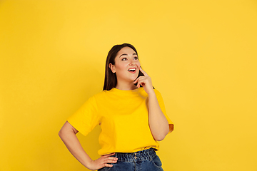 Image showing Caucasian woman\'s portrait isolated on yellow studio background