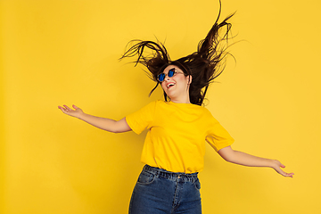 Image showing Caucasian woman\'s portrait isolated on yellow studio background