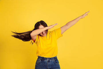 Image showing Caucasian woman\'s portrait isolated on yellow studio background