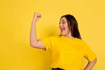 Image showing Caucasian woman\'s portrait isolated on yellow studio background