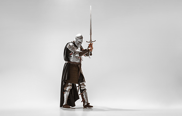 Image showing Brave armored knight fighting isolated on white studio background