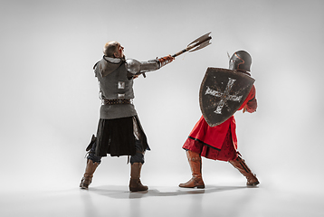 Image showing Brave armored knights fighting isolated on white studio background